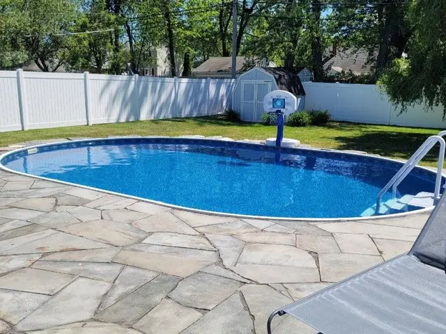 A flagstone patio around an in-ground pool