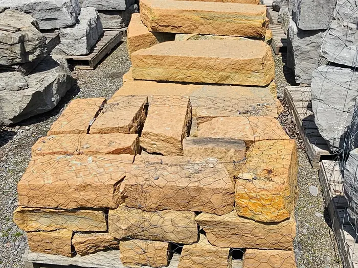Rustic Buff stackable wall stone on pallets in the yard